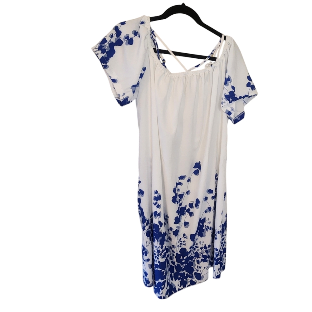 White and blue floral dress. Short sleeve. Can be worn off shoulders. Si…